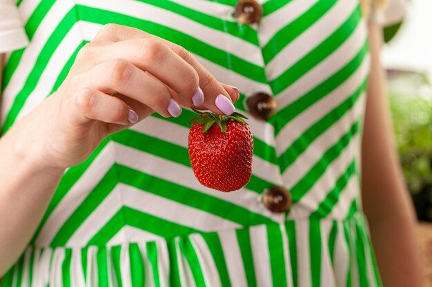 beautiful-large-red-strawberry-hand-close-up_93675-78488-1099850