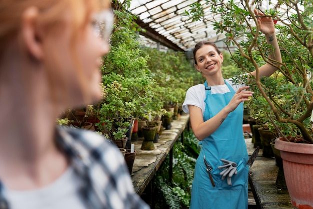 friends-taking-care-their-plants-greenhouse_23-2149037298-4691333