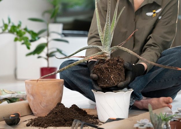 front-view-woman-gardening-inside_23-2149412545-9086568