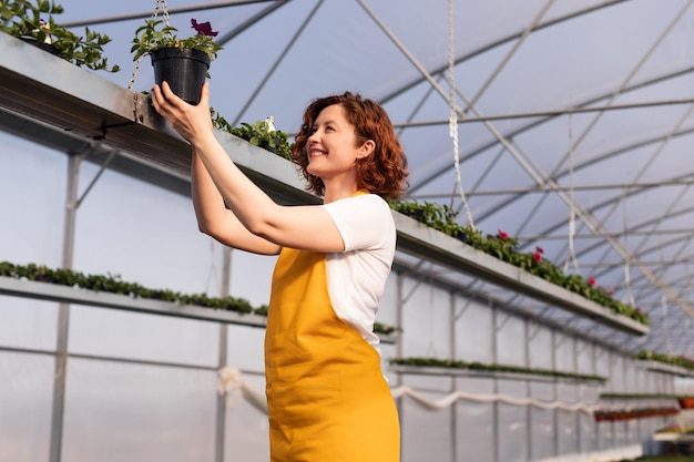 happy-gardener-examining-potted-flower_251859-18406-7494973