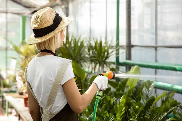 medium-shot-woman-watering-plants_23-2149098329-1963868