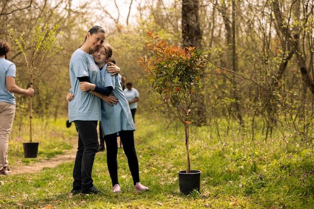 portrait-mother-child-protecting-natural-ecosystem-by-planting-trees_482257-97756-5685522