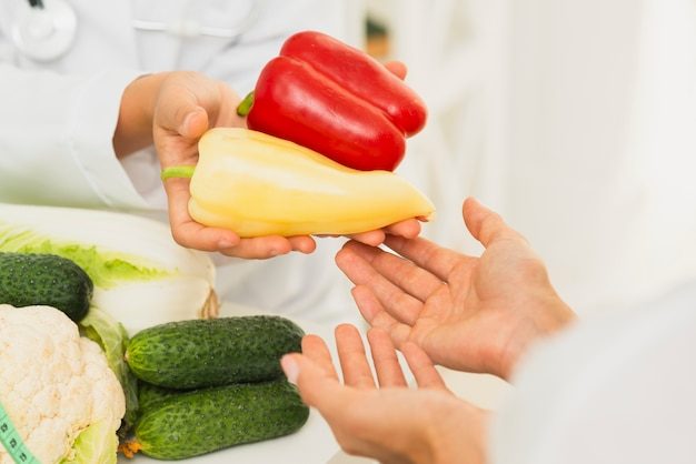 close-up-people-with-bell-peppers_23-2148302168-2390113