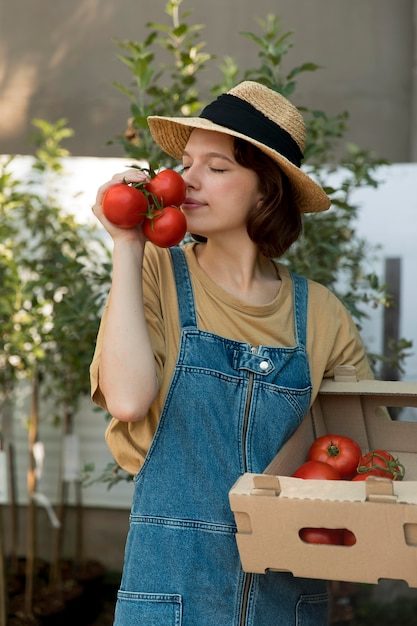 female-farmer-holding-some-tomatoes_23-2149072062-5988487