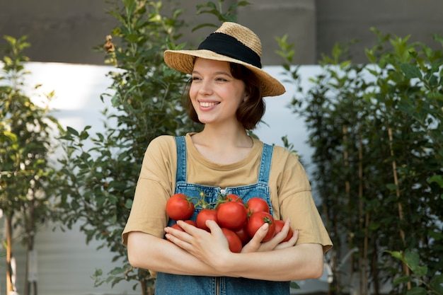 female-farmer-holding-some-tomatoes_23-2149072063-5240446