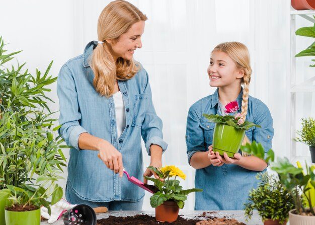 mother-daughter-working-together-greenhouse_23-2148414389-5244991