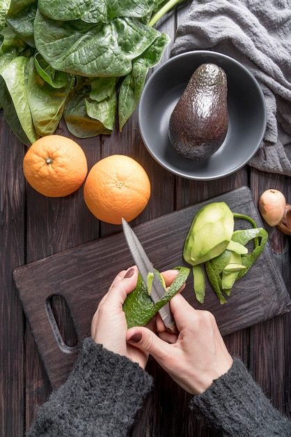 top-view-person-cutting-organic-avocado_23-2148538621-5956293